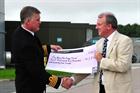 Captain Mark Garratt CO RNAS Culdrose presents a cheque to Mike Nixon of the Fly Navy heritage Trust