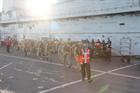 Embarking aid team of Royal Marines from HMS Illustrious