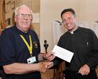 Reverend Martin Evans presenting a donation to Mr Jim Burrows of the Dorset & Somerset Air Ambulance