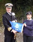 Captain Mark Garratt with Kettering Sea Cadets' efficiency burgee