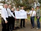Servicemen from RNAS Culdrose present a cheque for the Community Covenant to Porthleven School