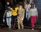 Migrants being assisted by the crew of HMS Bulwark