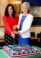 Kay Kendall and Louise Wainwright cutting the cake