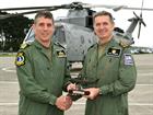 Lt Cdr Gary Jaggers receives a Merlin gift from Commander Steve Thomas CO 824 Sqn