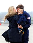 LAC John Brindley hug wife Lucretia and George (1) after returning home to 815 Naval Air Squadron at