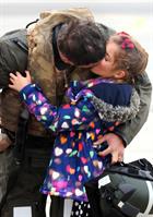 CPO Steve Wilson kisses daughter Nat (7) after returning home to 815 Naval Air Squadron at RNAS Yeov