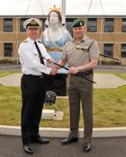 Commander Terry Tyack and Corps RSM, RSM Ally McGill handing over the RSM’s Cane 