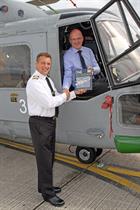 Handing over the first copy of the Lynx Manual to Cdr Phil Richardson at Yeovilton.  (credit: Steve 
