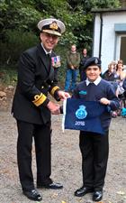 R. Admiral Blount presents Leading Junior Cadet Macfarlaine with the 2016 Burgee