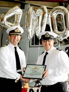 Rear Admiral Keith Blount presenting Si with a certificate for his 4000th Hour