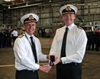 Rear Admiral Keith Blount presents Commander Simon Collins with his LSGC Medal