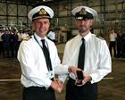 Rear Admiral Keith Blount presents Lieutenant Commander Chris Grey with his LSGC medal for 17 years