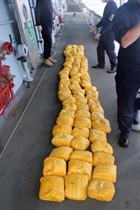 The bales of heroin seized from the dhow lined up on the deck of HMS Westminster