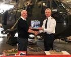 Phil Thomas presents Tiger striped Merlin to Capt Matt Briers RN CO CHF