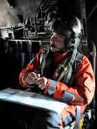 Cpl Justin Morgan in the back of the SAR helo