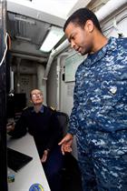 Lt Townsend discusses a forecast with a US Navy colleague
