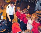 Petty Officer Austin Power showing the children a Helicopter gear box