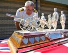 Commodore Jock Alexander inspects the trophy