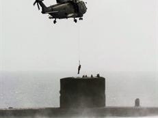 Merlin winching from a submarine on an exercise