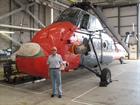 Barrie Derrick next to a Wessex helicopter