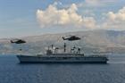 Merlin Helicopter with under-slung load past HMS Illustrious off the Albanian coast