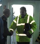 The Master of MV Sea Breeze is welcomed on board HMS Tyne by Lieutenant John-Paul Fitzgibbon RN