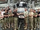 Chief Aircrewman Ronnie Barker centre right receiving a cake to celebrate his 3000 Flying hours