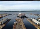 Tug boats move HMS Queen Elizabeth out of her dock