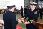Cdr Glyn Owen CO of 702 NAS hands the 702 crest to RAdm Harding