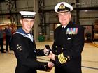 AET Alex Fisher receives the Queen Medal for Champion shots from Captain Mark Garratt