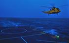 A Sea King from 1564 Squadron prepares to land on Clyde at night