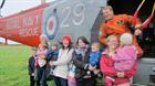 Lt Cdr Andy Watts along with some of the mothers and babies who are grateful to 771 NAS