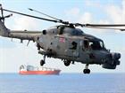 A Lynx Mk 8 helicopter, from 815 Naval Air Squadron, escorting a UN ship evacuating Chemical Weapons