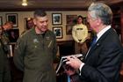 Defence Secretary Michael Fallon presenting a gift to Captain Daniel Grieco, Commanding Officer of t