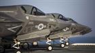 Four F-35B Lighting II Joint Strike Fighters sit secured to the deck after their arrival aboard the 