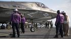 Marines and sailors aboard the USS Wasp (LHD-1) secure and refuel an F-35B Lightning II Joint Strike