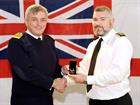 Fleet Commander Sir Philip Jones KCB presents a LS&GC medal to PO Stuart McVey at RNAS  	        Cul
