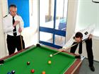 CPO Tregenza chats about his idea over a game of pool with Rear Admiral Blount  