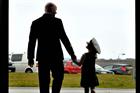 Veteran aircrewman WO1 Andy Penrose leaves 771's hangar with his daughter