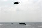 The Merlin helicopter hovers over the dhow found to have over 70 bales of pure heroin on board 