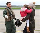 Pilot Lieutenant Oliver Brooksbank being met by his wife Frankie and daughter Evelyn