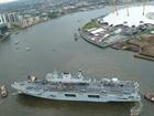 HMS Ocean being piloted up the Thames to Greenwich
