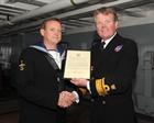 AET Williams being presented with his commendation by Rear Admiral Tom Cunningham
