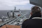 HMS Prince of Wales Captain Darren Houston observes taking on fuel from RFA Tiderace