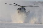 A Merlin Mk4 begins to disappear in a snowcloud