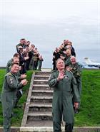 Staff at 750 NAS applaud Andy McKie after his last flight