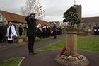 Commodore Paul Chivers, Commanding Officer RNAS Yeovilton, salutes having laid the Remembrance wreat