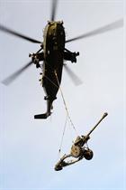 Aircrew guide their helicopter to the landing site