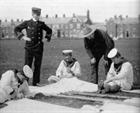 Naval personnel helping Samuel Cody assemble one of his man-lifter kites at Woolwich