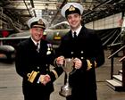 Rear Admiral Charlier presents the Bill Murton Trophy to Lt Tom Morris RN